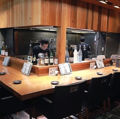 【カウンター席：8席】一枚板を贅沢に使用したカウンター席。職人の手仕事を間近に感じ、旬の料理を味わう特等席です。木の温もりと落ち着いた照明が大人の時間を演出。仕事帰りの一人飲みや大切な方との記念日、デートにも最適です。時間がゆっくりと流れる上質な空間で、心地よい会話と自慢の料理をお楽しみください。