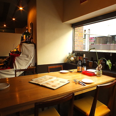 映画館通りを見下ろせるテーブル席。　夜の街の雰囲気を感じながら、落ち着いた空間で、ワインやイタリアンをお楽しみいただけます。