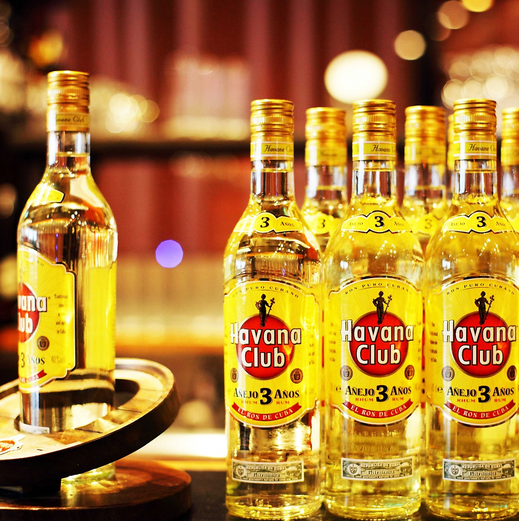 ―　カウンターに並べられたお酒のボトルが、照明の光を反射してキラキラ輝きます　―