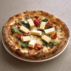 罪と幸のピッツァ（アンチョビ・モッツァレラ・セミドライトマト・バジル・バター）の写真