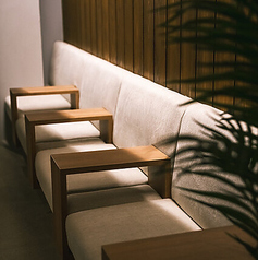 【ソファー席】落ち着いた雰囲気の中、広々とした、座り心地の良いソファー席をご用意しております。木の温もりを感じられるデザインで、ゆったりとおくつろぎいただけます。友人との会話や、一人でのリラックスタイムに最適な空間です。