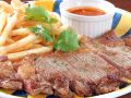 料理メニュー写真 ステーキ/骨付き肉・BBQソース/チキンエンチェラーダ/牛肉のエンチェラーダ