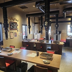 4名様用のテーブル席や2名様用テーブル席など、多彩なお席が機能的に配置されています。木目調のテーブルに赤いチェアが映える清潔感のある内装で、活気がありながらも落ち着いた雰囲気です。