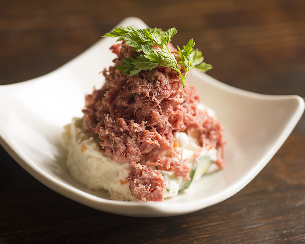 手作りのポテトサラダの上に、コンビーフをのせた、当店人気のポテトサラダ。