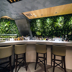 落ち着いた照明。お一人で静かにお酒を楽しみたい時や、大人のデートに最適です。背面に広がる豊かな壁面緑化が印象的な、開放感があり所作を楽しめるライブ感あるお席