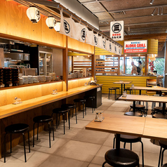 広々とした開放的なフロアに並ぶテーブル席は、友人同士や仕事仲間との賑やかな宴に最適です。温かみのある木の質感を活かしたデザインとモダンなインテリアが調和し、カジュアルながらも落ち着いた雰囲気。席の間隔も程よく確保されており、周囲を気にせず名物の餃子とお酒を心ゆくまで楽しめます。