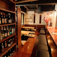 圧巻のボトル棚がお出迎え！こだわりのお酒を楽しむ席