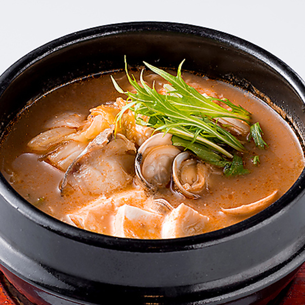 天壇特製チゲ。本場韓国の味わいを活かした豊富なサイドメニューにもこだわりを。