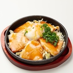 熱々の鉄板で焼くチャーシューエッグ。とろける卵の黄身を濃厚なタレに絡めて食べるのが醍醐味。