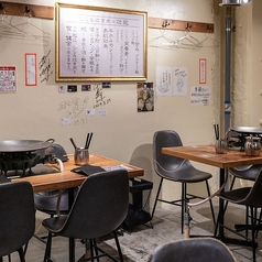 4名様用のお席あり。木目調の暖かい雰囲気に包まれた当店では、背もたれのある快適な椅子でゆっくりとおくつろぎいただけます。机の中心には特製の鉄板があり、目の前で焼き上げる料理を楽しむことができます。また、換気も抜群で、安心してお食事をお楽しみいただける環境が整っています。