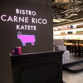 虎ノ門駅から徒歩3分の好立地に、まるで劇場街のような肉バル『Carne Rico Katete』。ブロードウェイを彷彿とさせる店内は、明るく楽しい雰囲気。目立つ牛ロゴがトレードマークです！